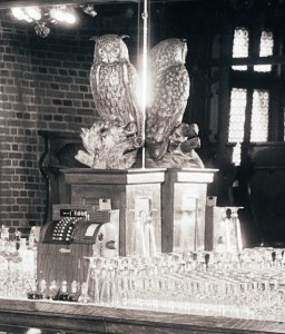 A wise owl sits atop what seems to be a simulated woodgrain cash register. Not a good era for cash registers. Detail SVF Baltimore Hotels Inns & Taverns Belvedere Hotel 1934 Interiors Barroom, MdHS. 