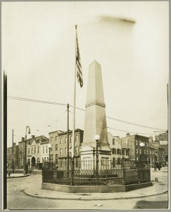 Street scene. Wells and McComas Monument. Gay and Monument Streets, Baltimore, ca. 1920-1930. MdHS, 1995.62.081.  
