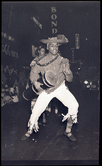 Halloween Dancers on "the Block", Baltimore Street, 1939 (Halloween Dancer, Baltimore Street, 1939, Robert Kniesche, PP79.574.1, MdHS.)