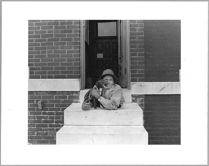 Sideshow performer, painted screen artist, photographer, and lifelong East Baltimore resident Johnny Eck with his dog, Reds, on the stoop of his home at 611 N. Milton Avenue in McElderry Park. Eck (born John Eckhardt, Jr.), was born without the lower half of his body, and became one Eck is only one of the more famous residents of East Baltimore photographed for the East Baltimore Documentary Photography Project between 1976 and 1980. The Amazing Johnny Eck, an exhibition featuring Eck’s memorabilia and works, is currently at MICA until March 16, 2014.Johnny Eck, ca 1977, Linda G. Rich, The East Baltimore Documentary Photography Project, Baltimore City Life Museum Collection, 1982.19.1.178, MdHS.