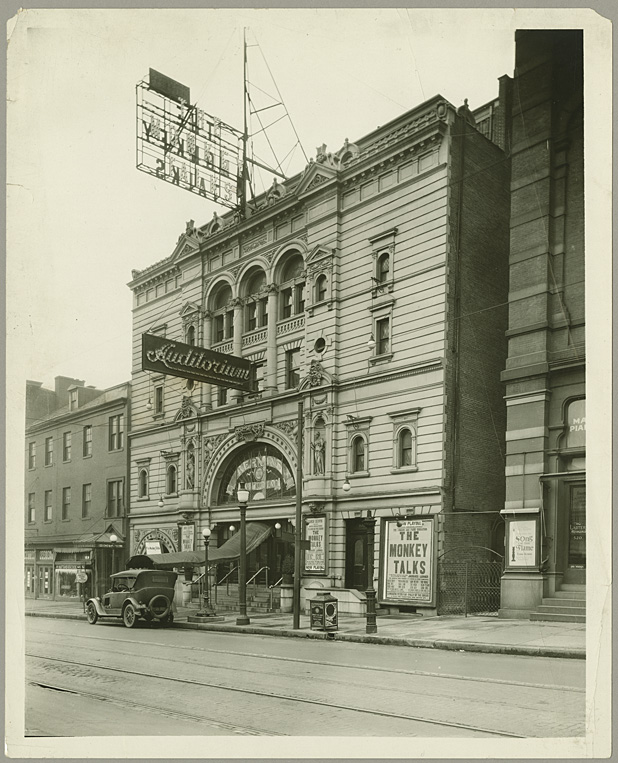 1994.42.042  Street scene.  Auditorium Theatre.  516 North Howard Street, Baltimore.  Also known as Kernan's Theatre and the Mayfair Theatre. Featuring "The Monkey Talks." Shows automobile parked in front. Ca. 1925. Unidentified photographer 8x10 inch silver gelatin print Julius Anderson Photograph Collection Baltimore City Life Museum Collection Special Collections