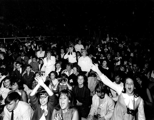 “The Civic Center screamed in feverish excitement like some sluggish animal finally come to life. Teen-agers, mostly, and girls, primarily, burst loose in hysteric recognition when the quartet appeared. They had come. It was real. The hanks of hair. The flesh. The electrocuting guitars that had left fainting bodies throughout the land.” 
