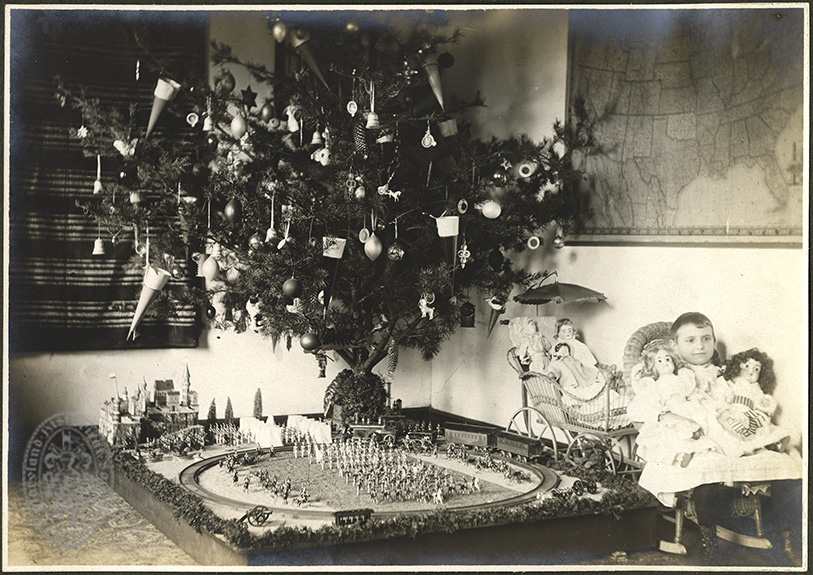 Christmas, West Arlington, Md., 1900. Unidentified child with Christmas tree and toys. Unidentified photographer, 1900. Clara Lips Album. PP149.06, MdHS.
