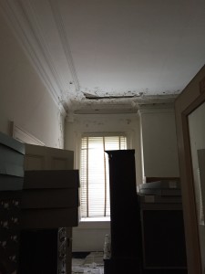 One of the rooms where costume is stored. The ceiling has some damage, and fragments are falling onto the floor. 