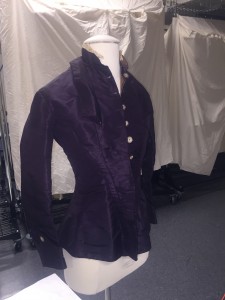 1974.61.1a Dark purple wedding dress bodice with mother of pearl buttons.