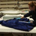 Adding a roll of acid-free tissue to the folds of this dress.