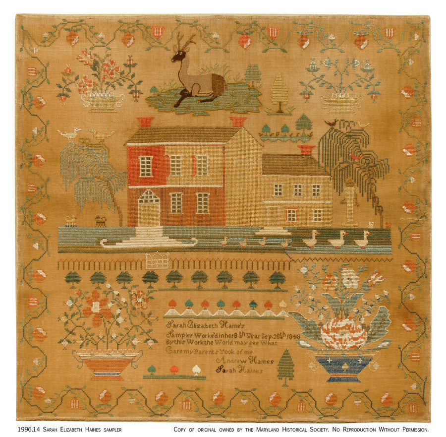 A sewing sampler of a house surrounded by plants and animals with a short inscription and vine border on a brown background.