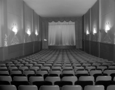 Stage and seats in theater, photograph by Paul S. Henderson (1899-1988), August 1953. Maryland Center for History and Culture, H. Furlong Baldwin Library, Baltimore City Life Museum Collection, Paul S. Henderson Collection, HEN.00.B1-021