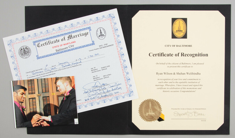Group of materials including a marriage certificate, a wedding photo, and a certificate of recognition.