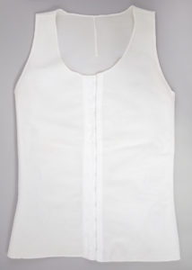 White chest binder that closes in front with hooks and eyes.