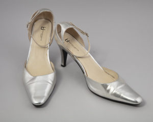 Pair of silver ;leather heels with ankle straps.
