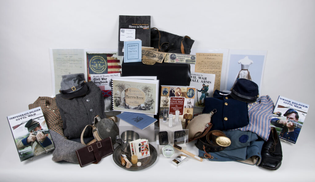 Objects in the Civil War trunk include books, uniforms, and replica objects from soldiers' daily lives
