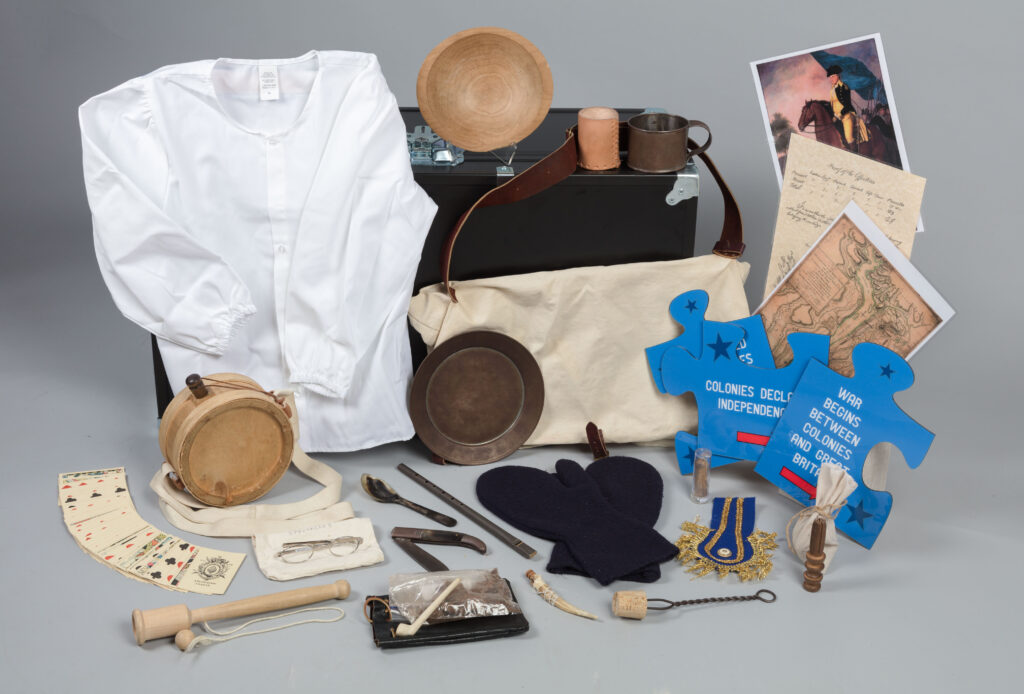 Object in the trunks include toys and tools, clothes, eating utensils, maps, and puzzle pieces for an education game