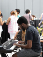 A man playing on an electric piano